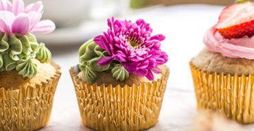 3 cupcakes with a floral design on top